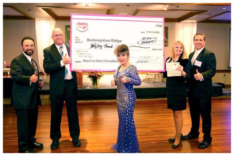 Dr Kim donates check to the Redemption Ridge fundraiser