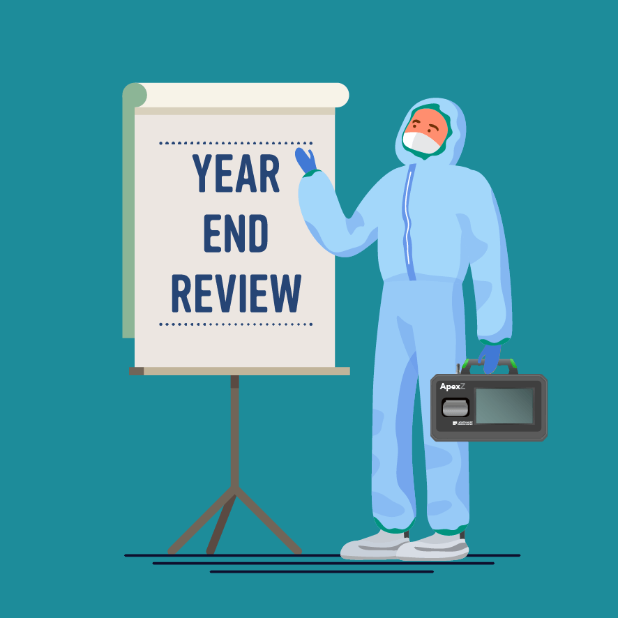Cleanroom Guy standing next to board that says "Year End Review"