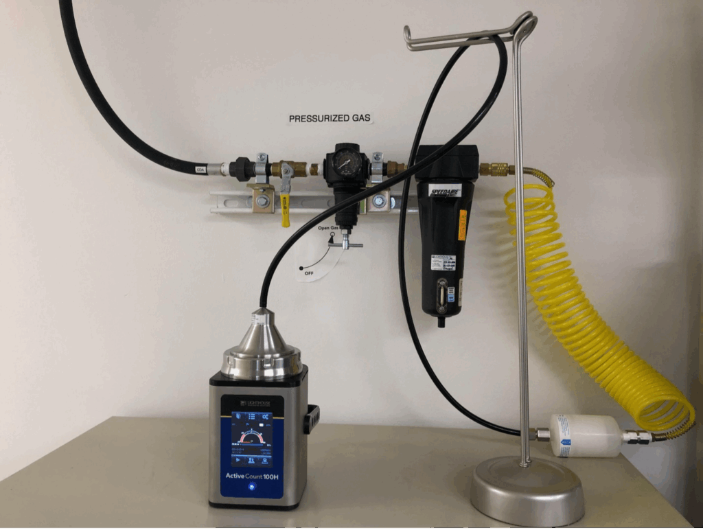 A photograph of an ActiveCount Microbial Sampler configured for gas sampling within a cleanroom environment.